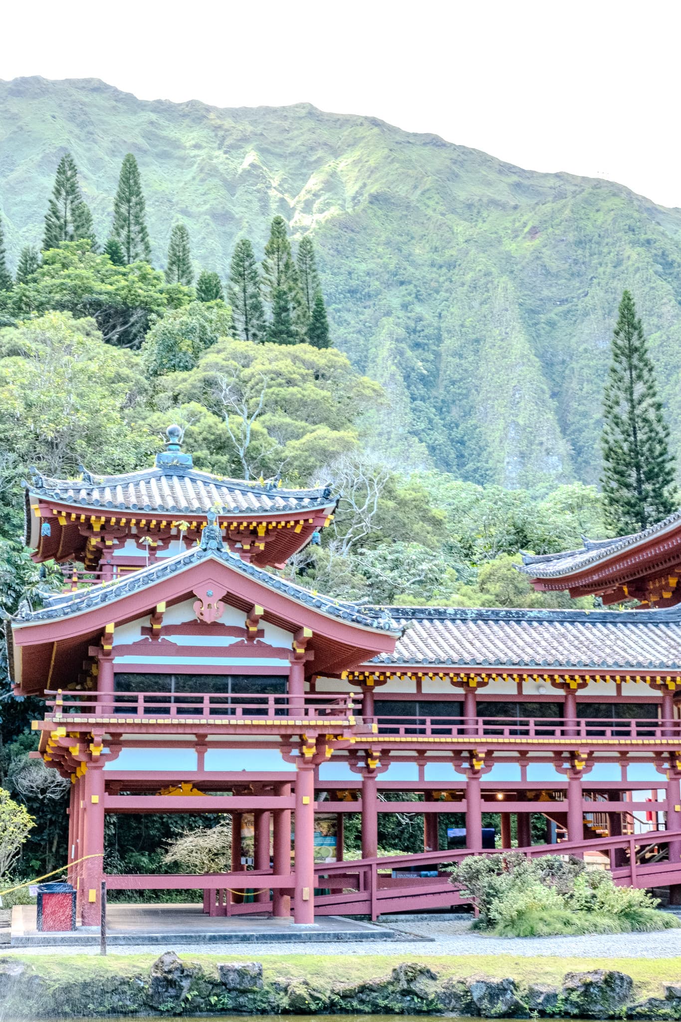 Red Byodo-In Temple beneath green mountains