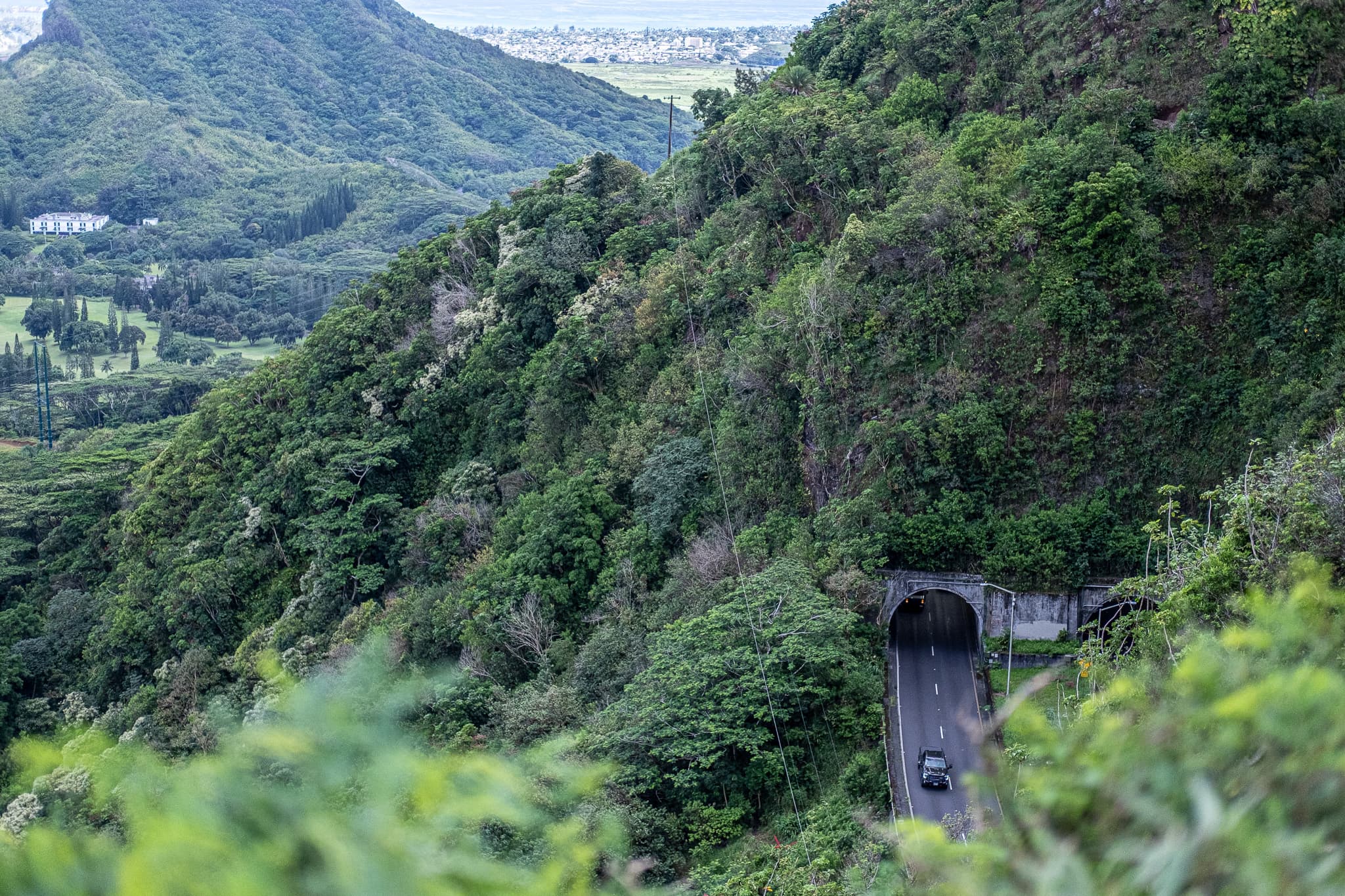 Road tunnel in a lush green mountainside