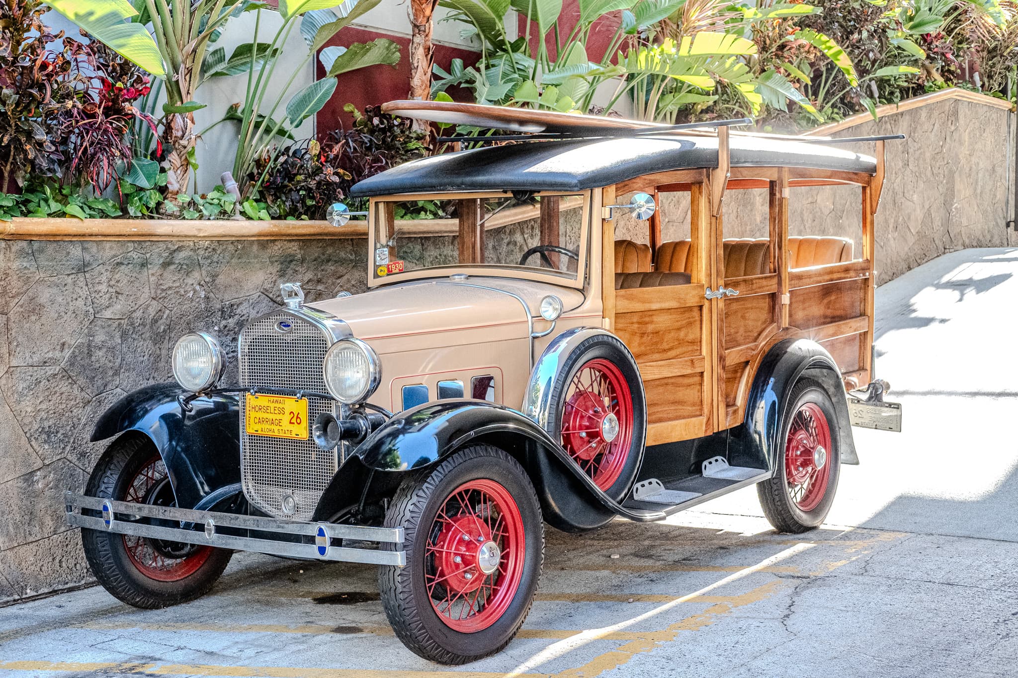 Vintage wood-paneled car with red wheels