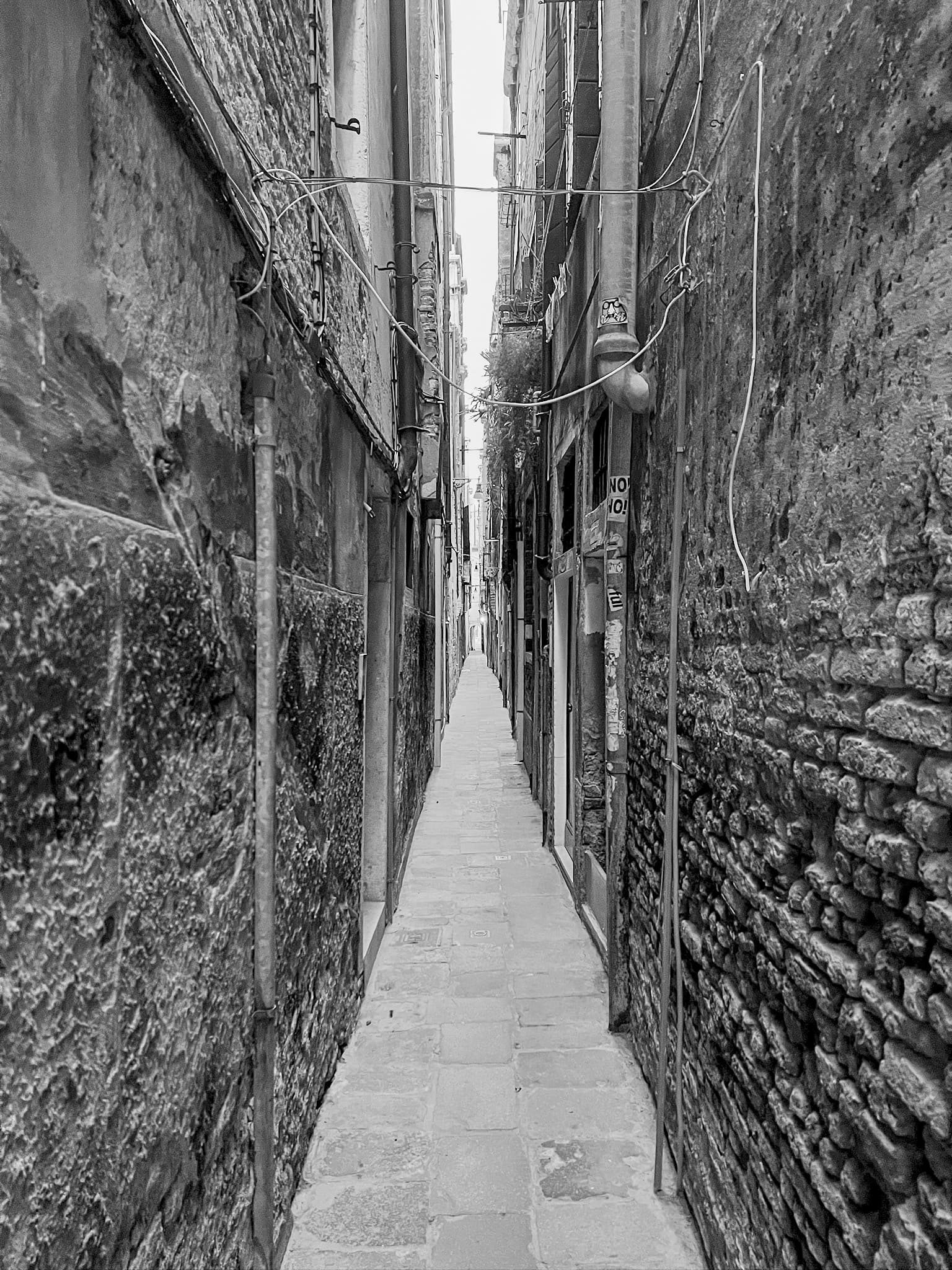 Narrow alley between brick walls