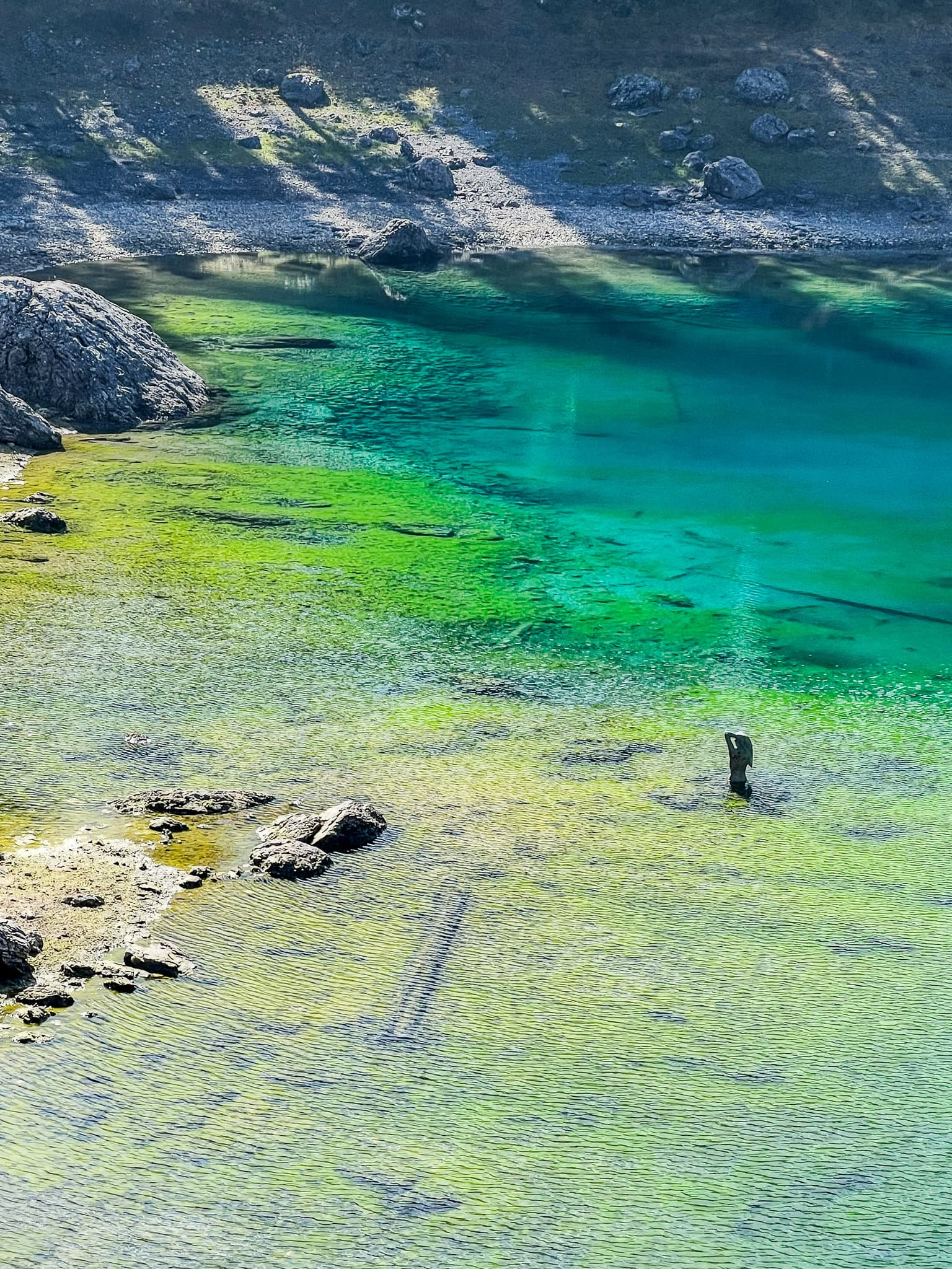 Clear emerald water over shallow rocks