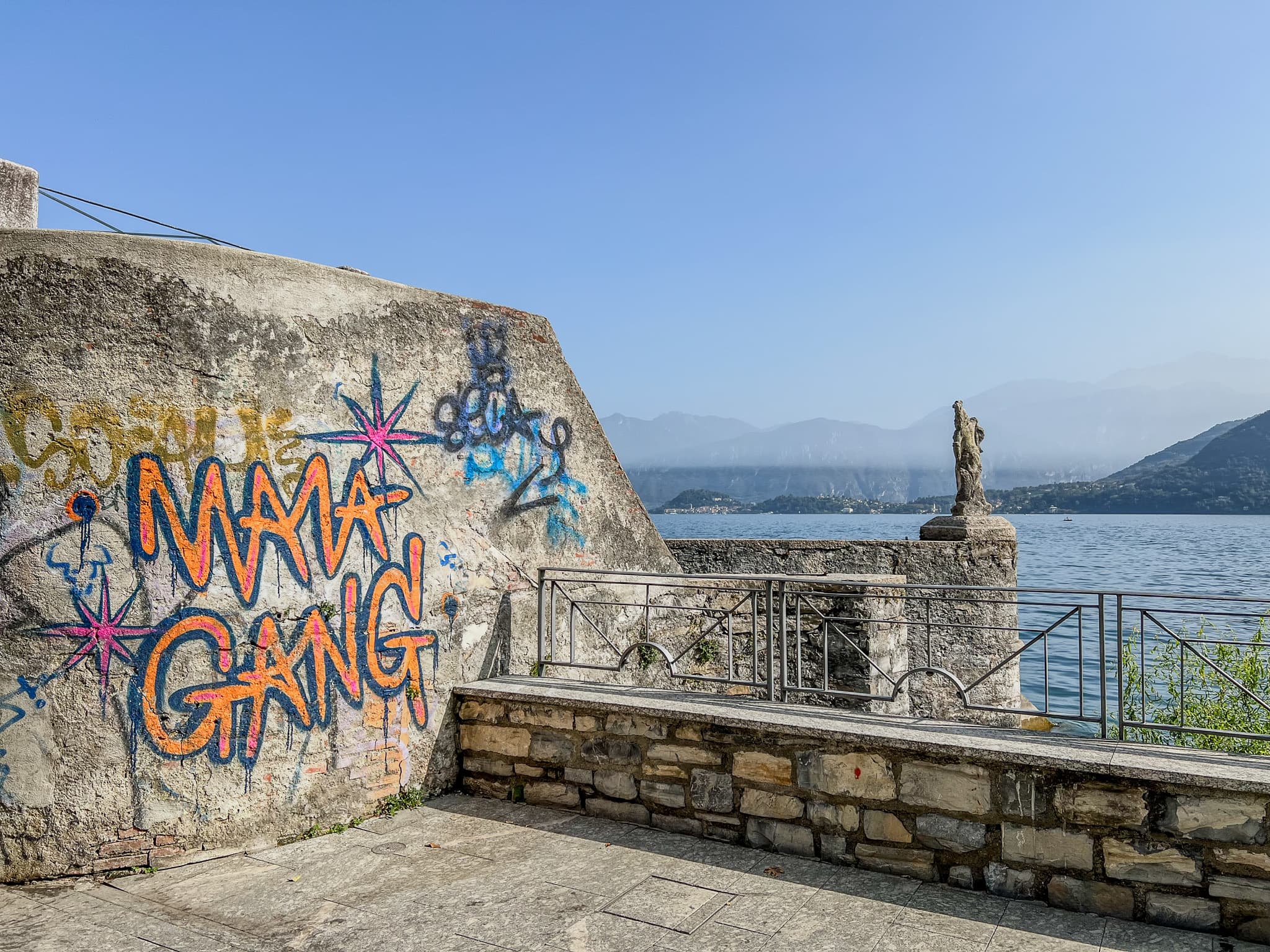 Graffitied wall on a lakeside terrace