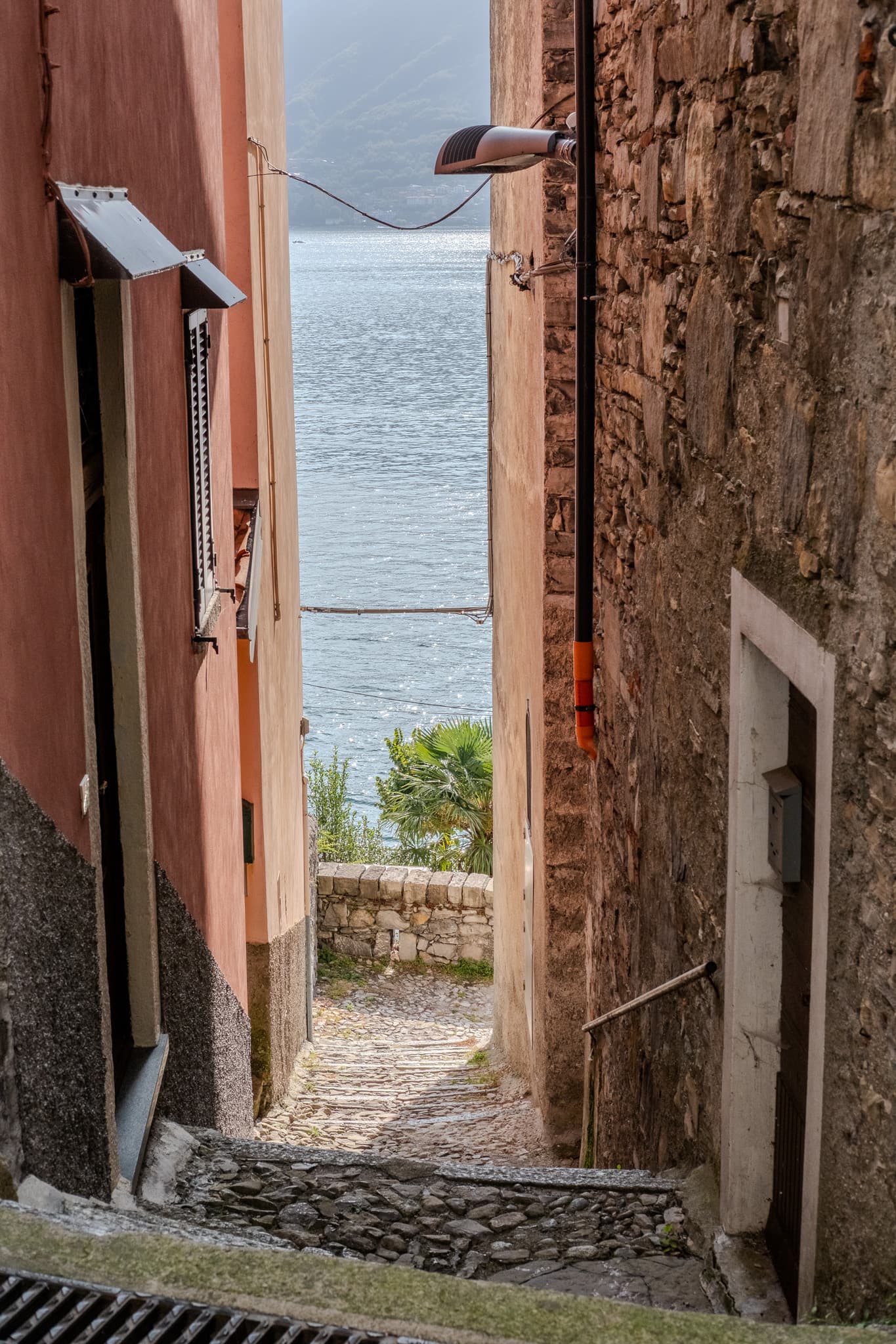 Narrow stone lane opening onto the lake