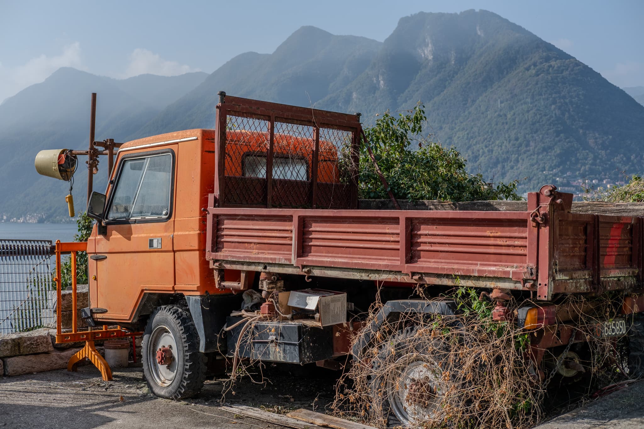 Orange work truck with mountains behind