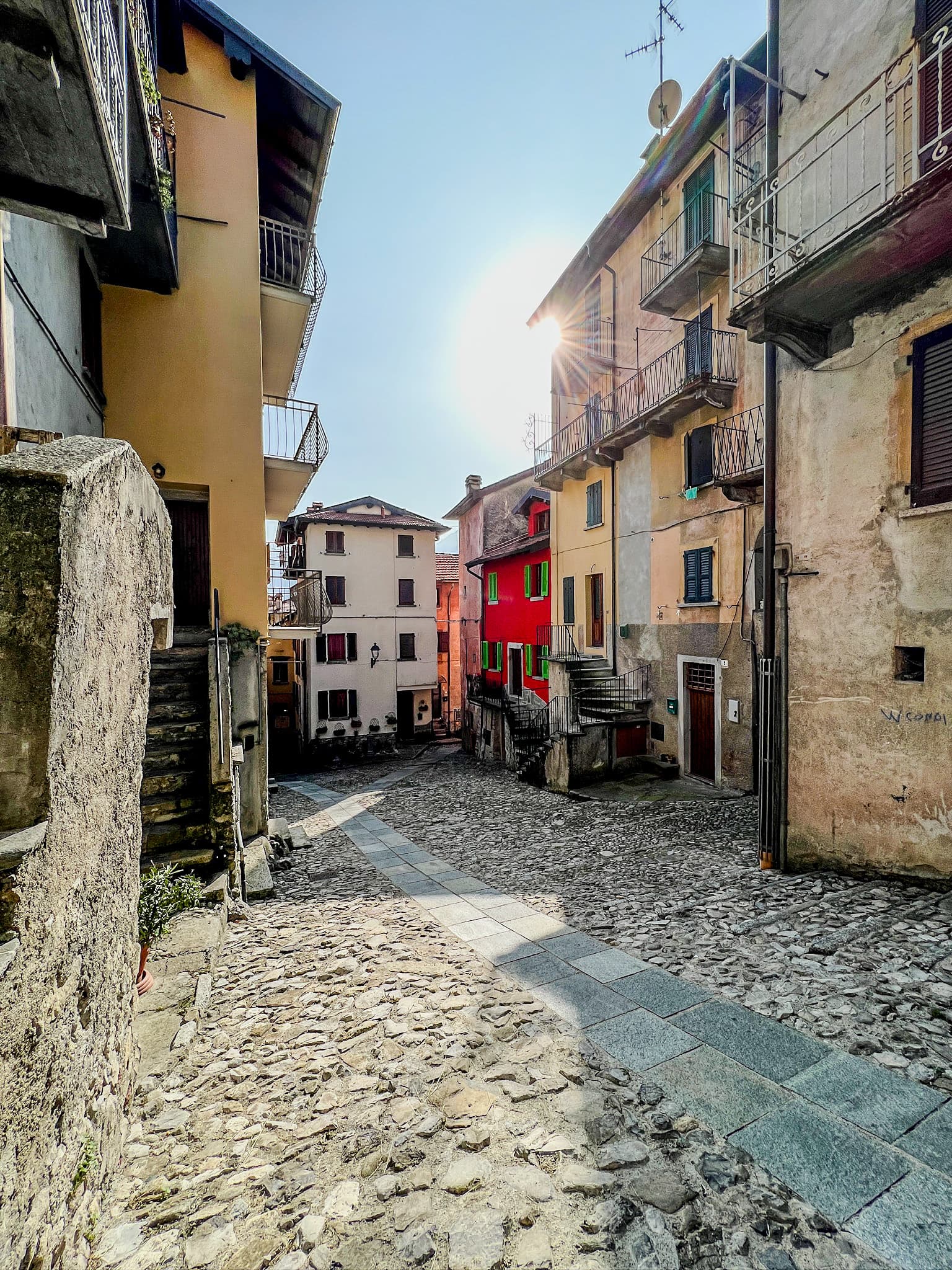 Sunlit cobbled village street