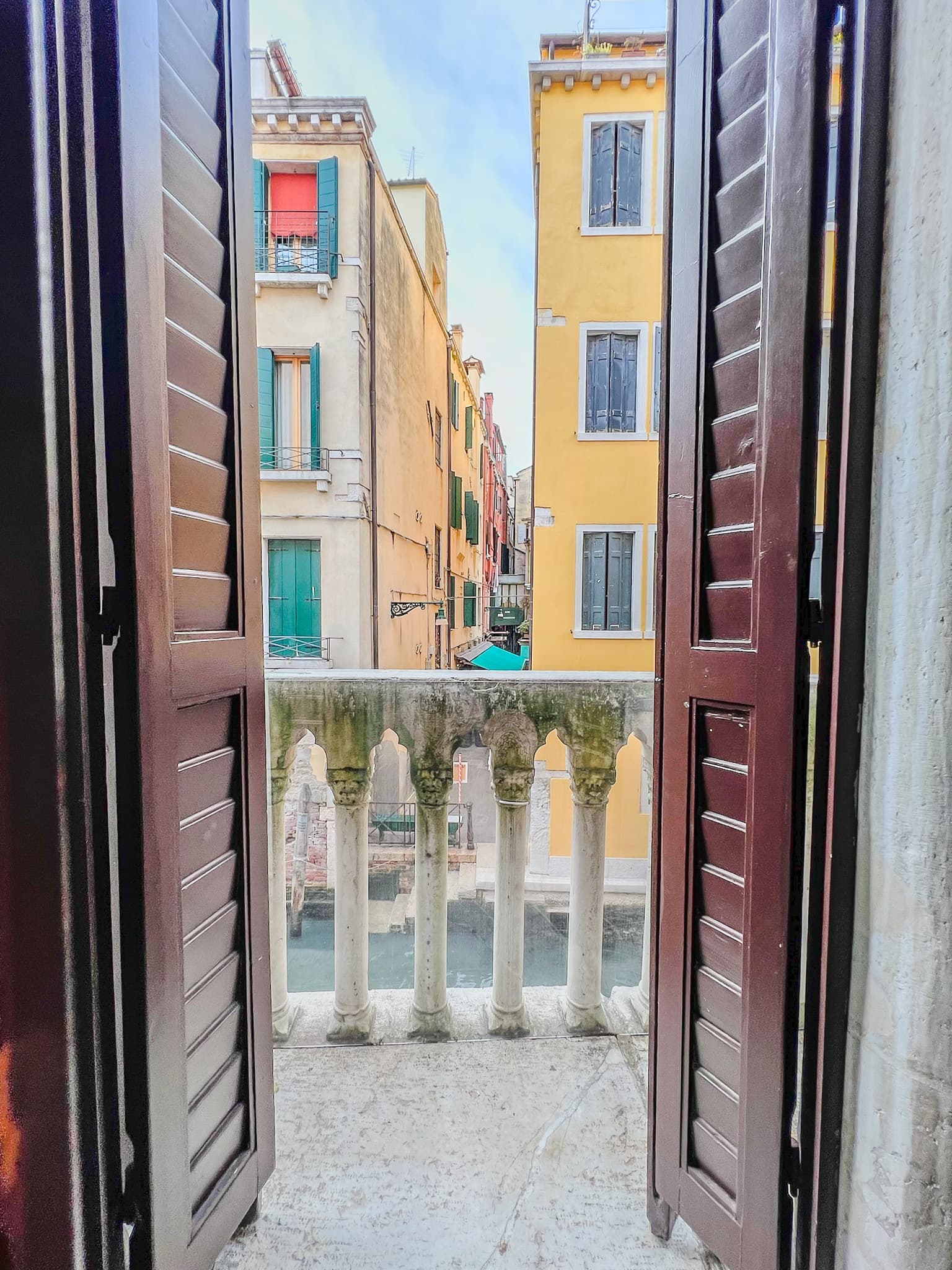 Open shutters onto a Venetian street