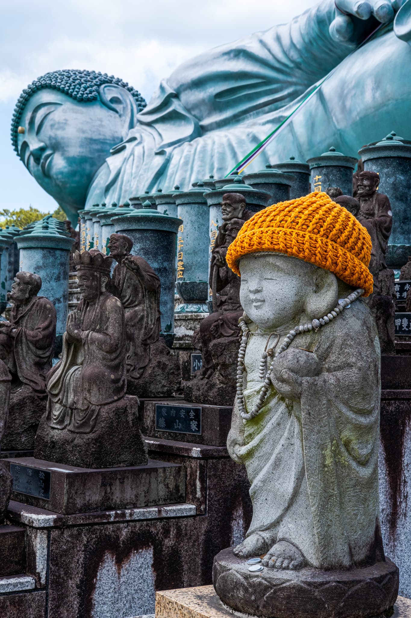Stone statue wearing an orange knit hat