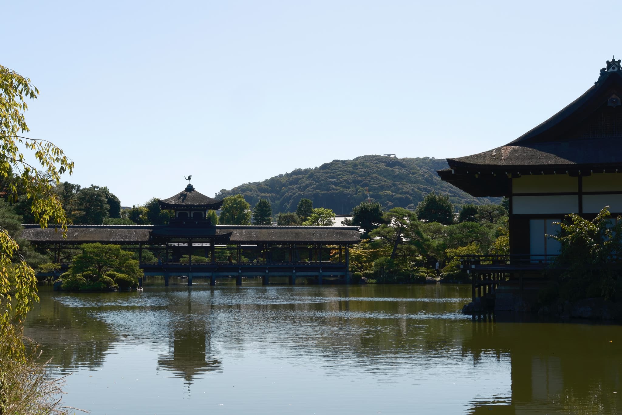 Temple hall and bridge reflected in a pond