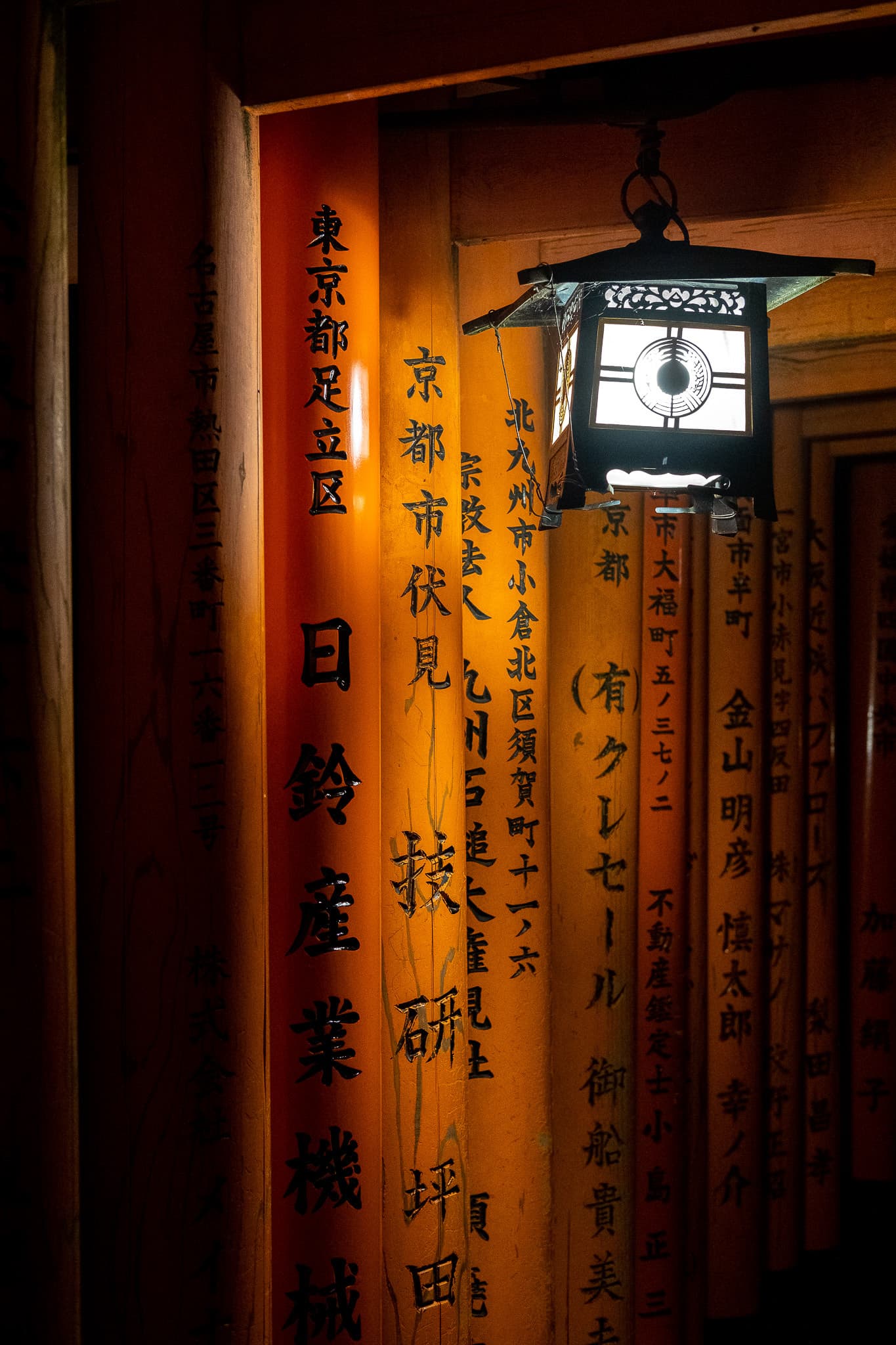 Lantern hanging on an inscribed torii gate