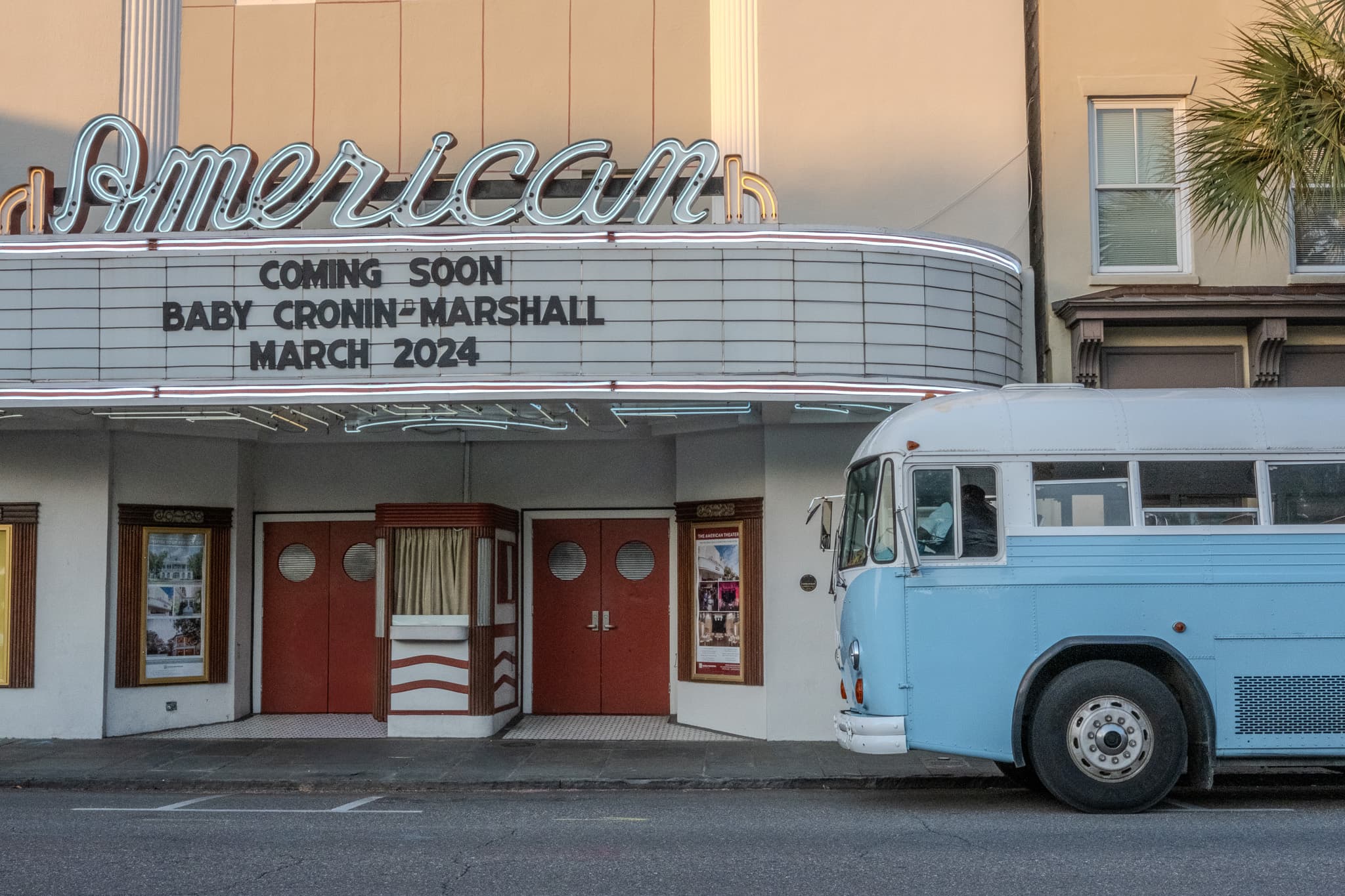 American Theater marquee with a vintage blue bus