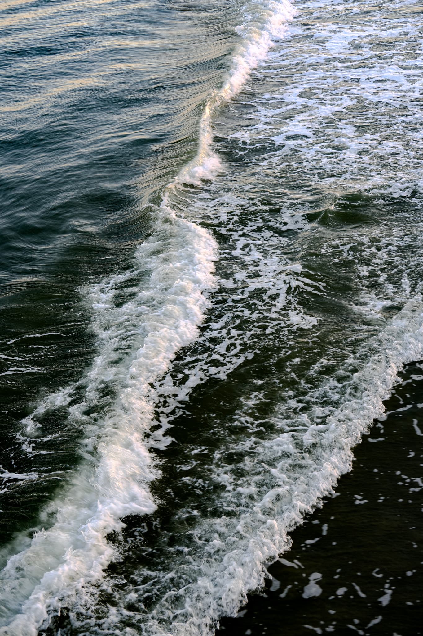 Breaking wave and white foam, seen from above