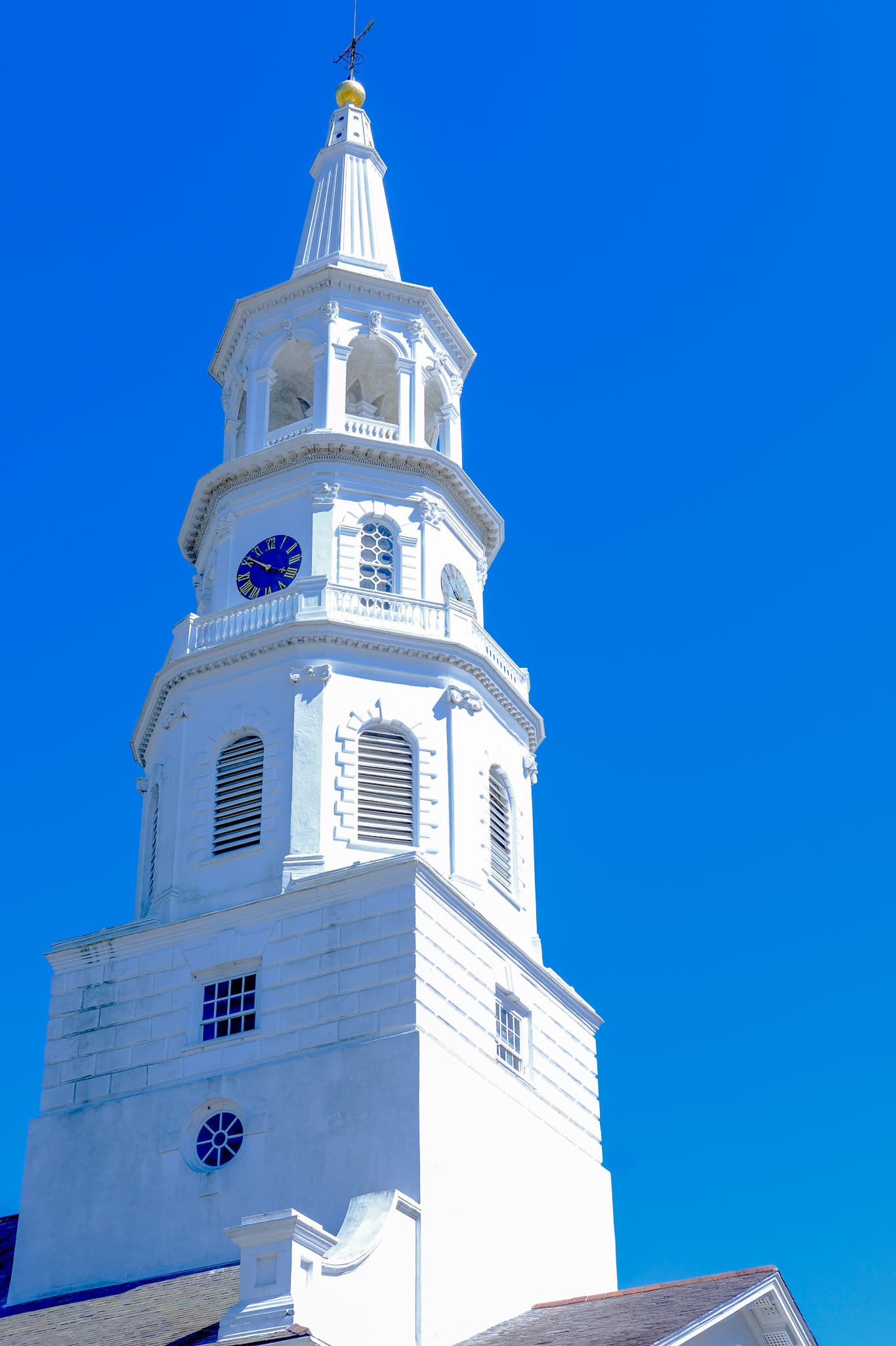 White church steeple against a deep blue sky