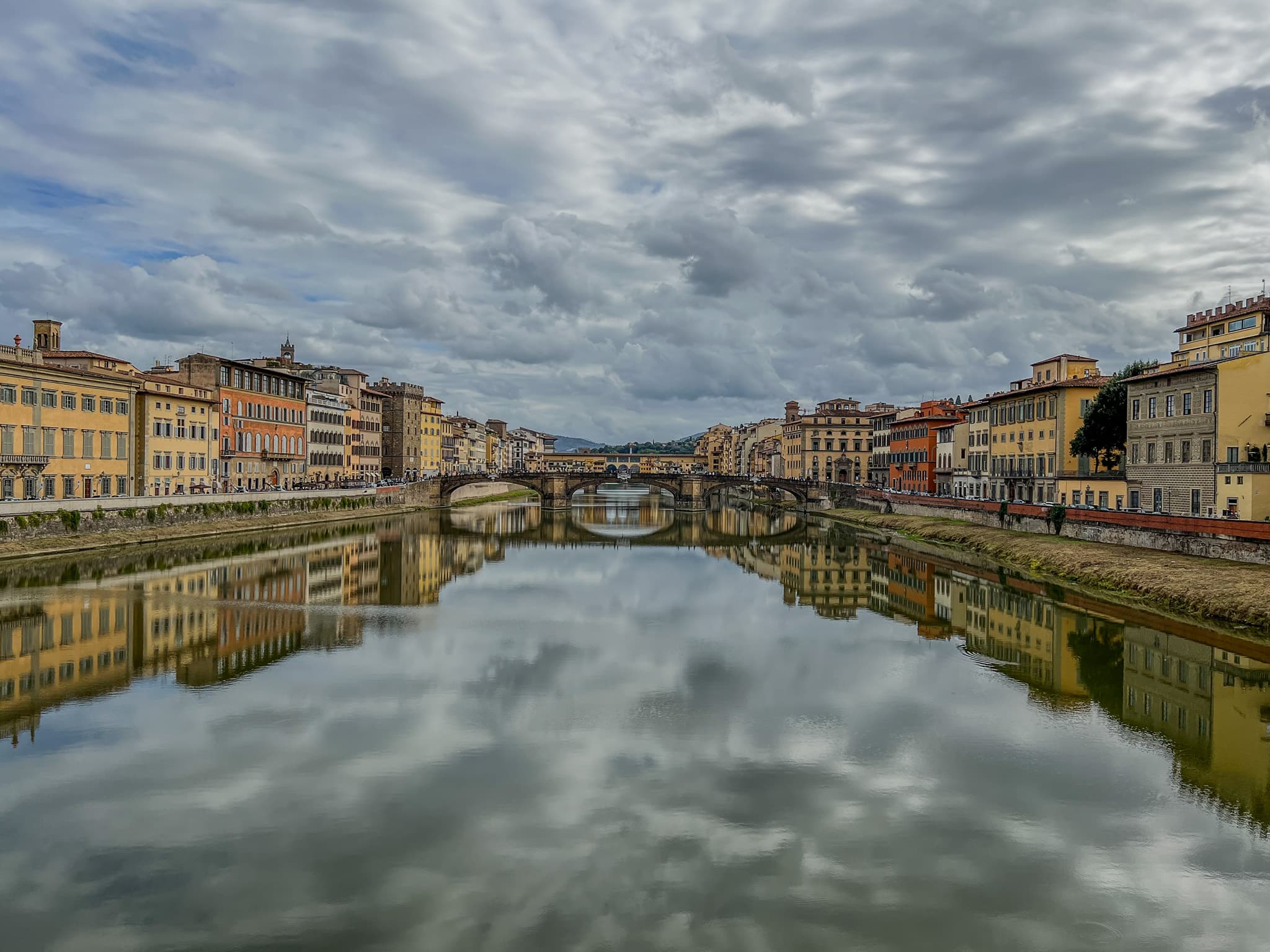 Clouds and buildings reflected in the Arno